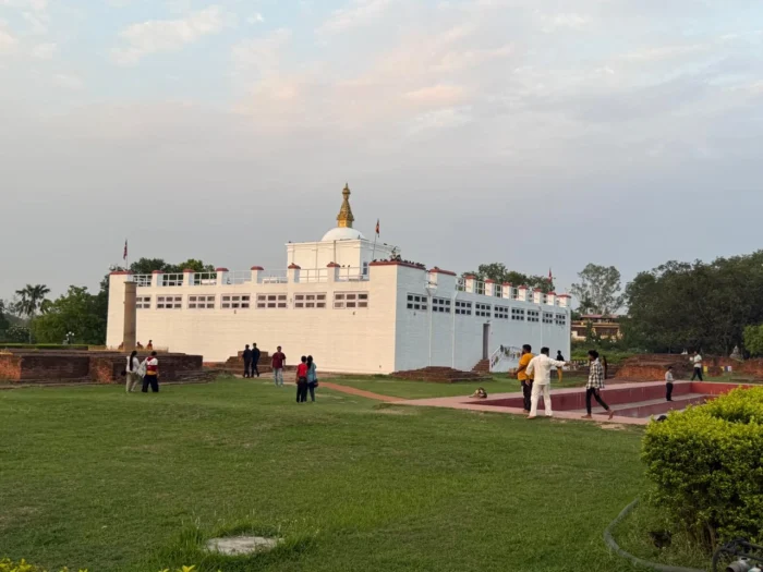 Maya Devi Temple in Lumbini, Nepal with visitors walking around the sacred garden